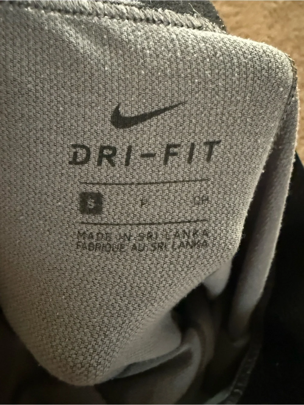 Nike women’s Charcoal Gray leggings with gold Swoosh